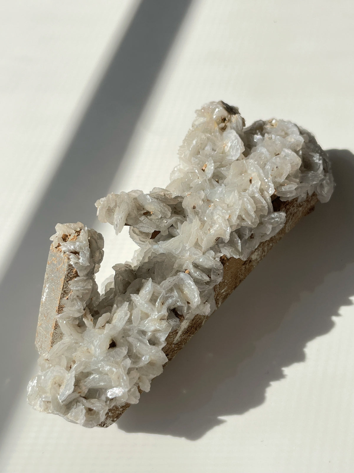 Beautiful crystal specimen featuring intricate flower calcite formations on a quartz base, showcasing natural textures.