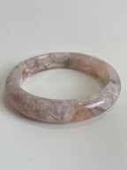 Beautiful flower agate bangle with soft pink hues and unique patterns, showcasing its natural crystal beauty.