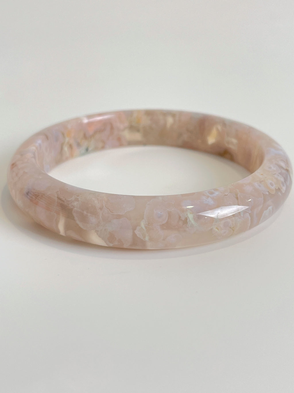 Beautiful flower agate bangle with soft pink hues and floral patterns, showcasing its unique crystal design.