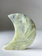 Beautiful green Maligano Jasper moon sculpture showcasing intricate patterns and natural textures.