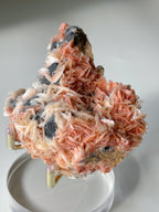 Beautiful pink barite and cerussite crystal specimen on galena, showcasing intricate textures and colors.