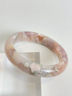 Beautiful flower agate bangle featuring soft pink and cream hues, showcasing natural patterns and textures.