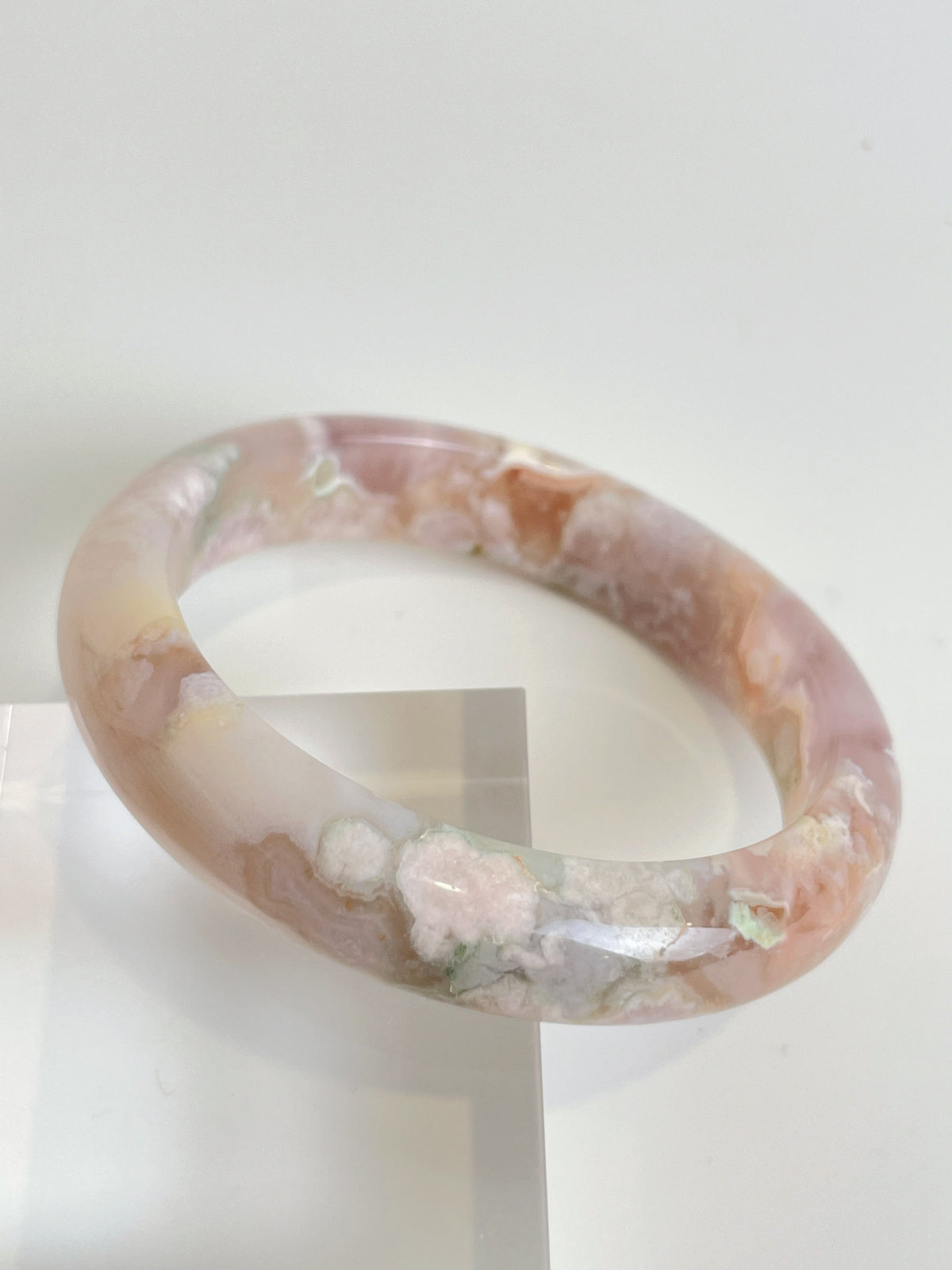 Beautiful flower agate bangle featuring soft pink and cream hues, showcasing natural patterns and textures.