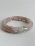 Beautiful flower agate bangle featuring soft pink and green hues, showcasing unique natural patterns.