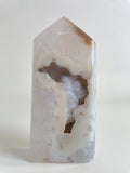 Druzy Agate Tower with a smooth, polished surface showcasing natural patterns and colors, highlighting its crystal beauty.
