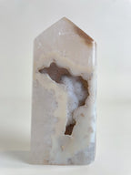 Druzy Agate Tower with a smooth, polished surface showcasing natural patterns and colors, highlighting its crystal beauty.