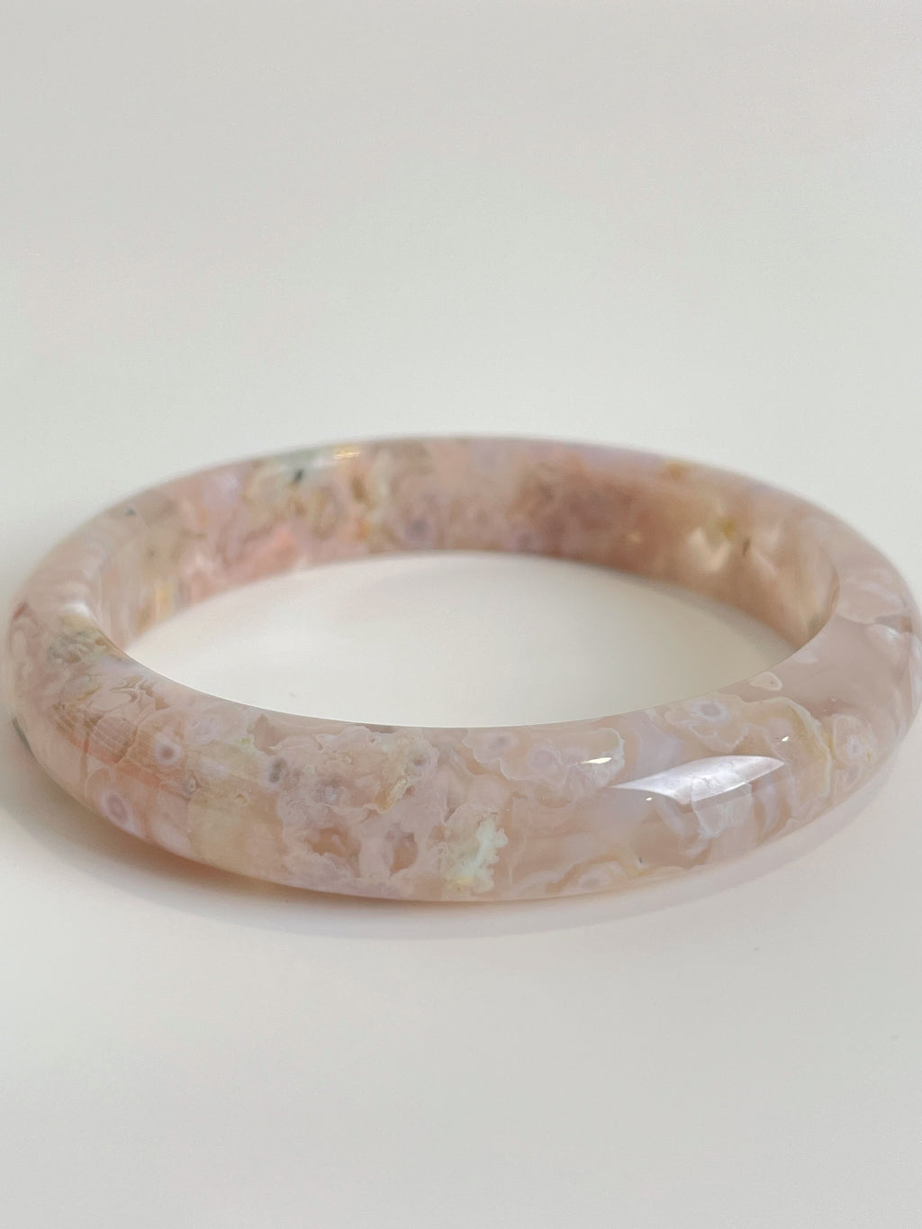 Beautiful flower agate bangle showcasing soft pink hues and intricate patterns, perfect for stylish accessorizing.