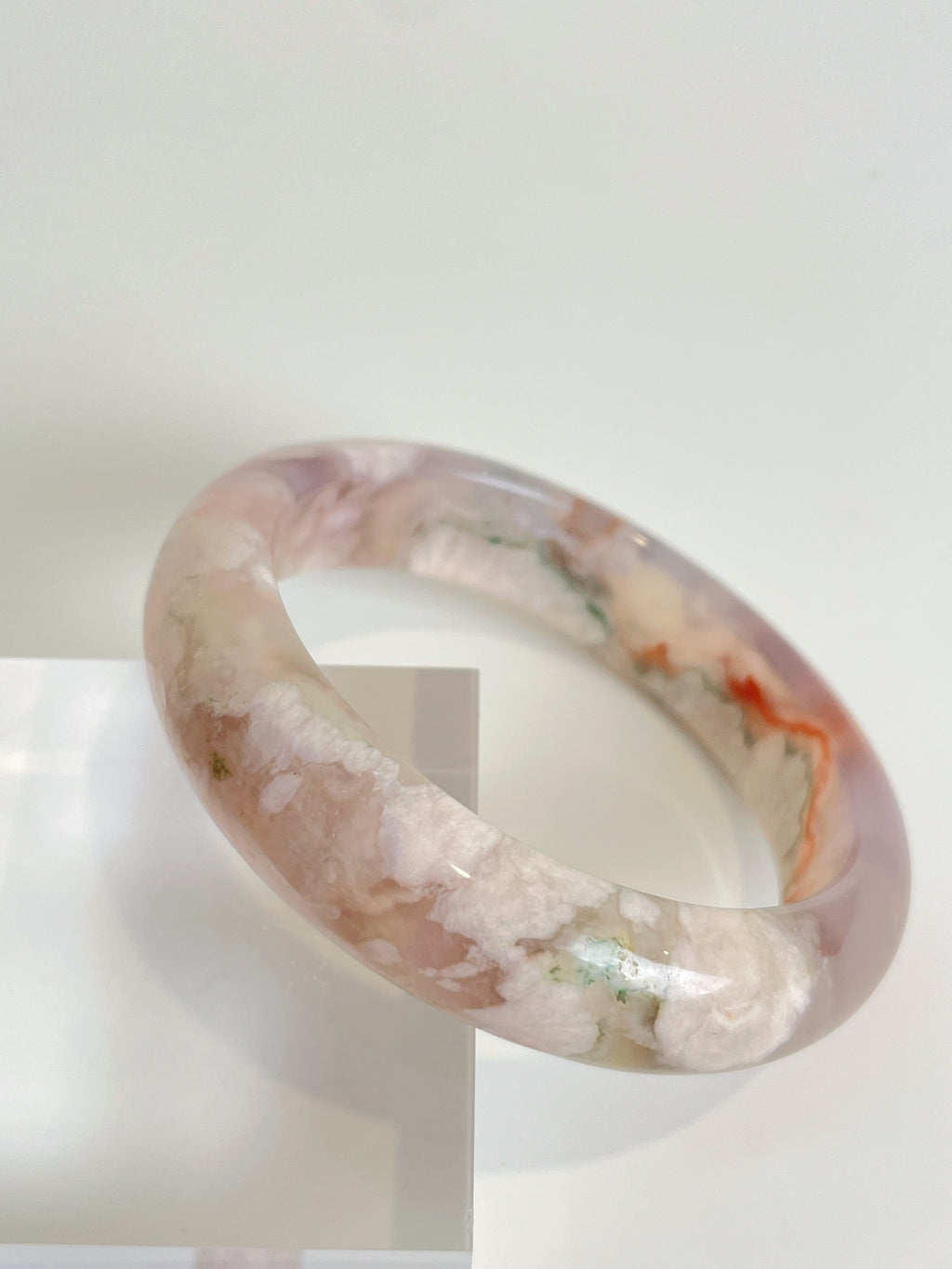 Beautiful flower agate bangle showcasing soft pink and white hues with natural patterns, perfect for stylish wear.